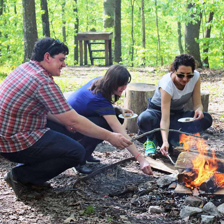Retreat participants build a campfire